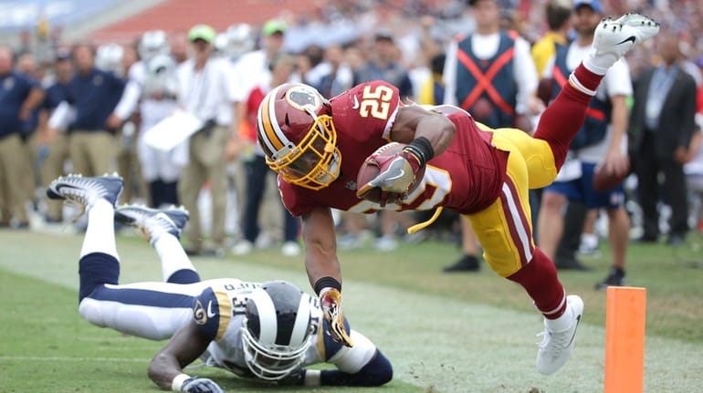 Chris Thompson of the Redskins leaps for the pylon to...