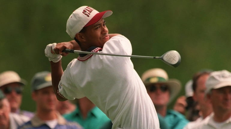 Tiger Woods drives off the 15th tee during a practice...