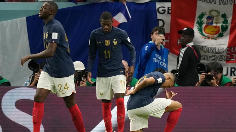 France's Kylian Mbappe kneels after he scored during the World...