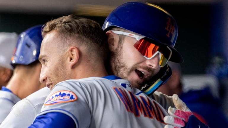Mets designated hitter Pete Alonso, right, is embraced by Brandon...