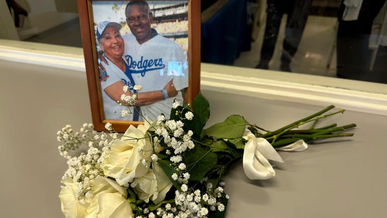 A framed photo of Margarita and Manny Mota along with...