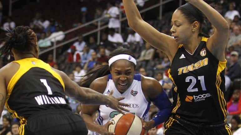 Cappie Pondexter drives to the basket through a double-team during...