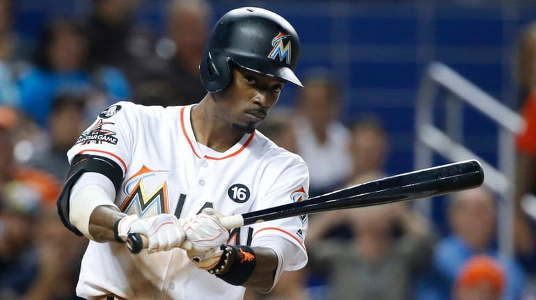 Dee Gordon practices his swing before batting during a game...