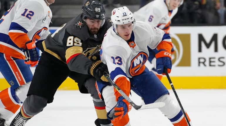New York Islanders center Mathew Barzal (13) skates around Vegas...
