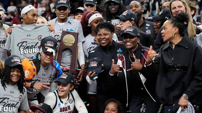 South Carolina celebrates with the regional championship trophy after defeating...