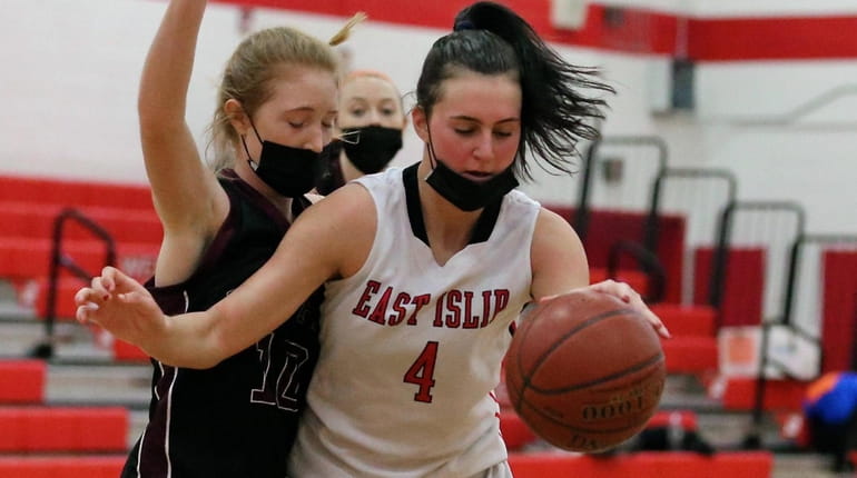 East Islip center Jess Peluso tries to drive the basket,...
