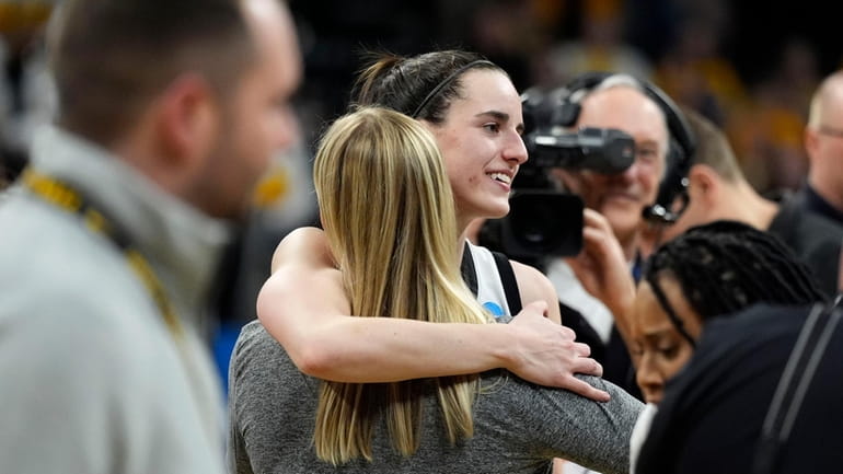 Iowa guard Caitlin Clark celebrates with teammates after a second-round...