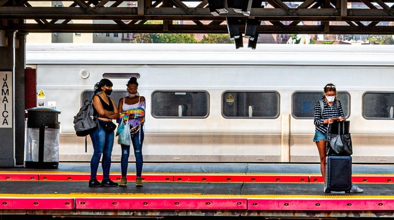Commuters wait at the Jamaica LIRR station in Jamaica in September...