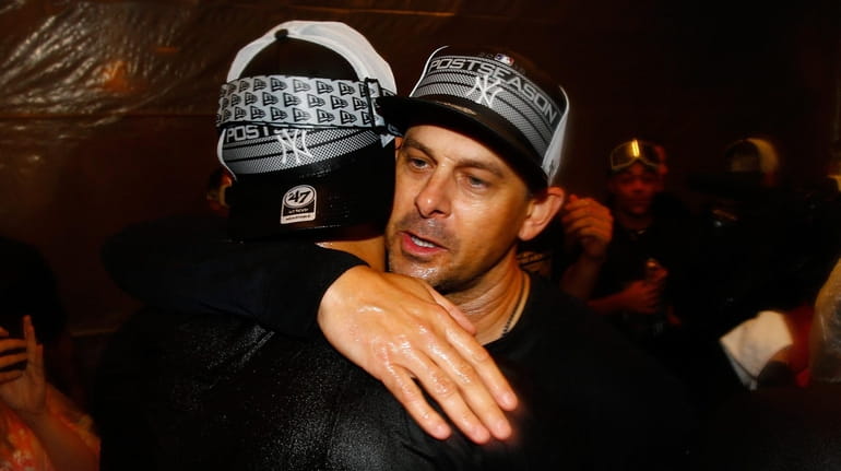 Aaron Boone of the New York Yankees celebrates clinching a...