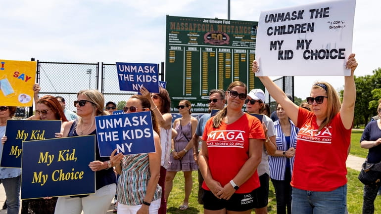 Parents rally against the school mask mandate at a park in...