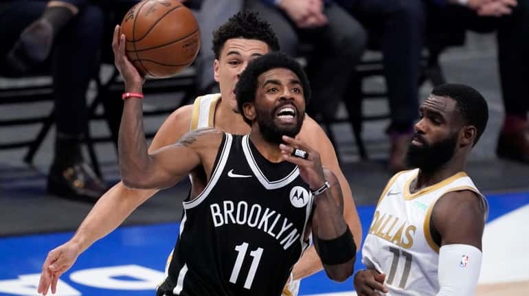 Brooklyn Nets guard Kyrie Irving (11) drives to the basket...