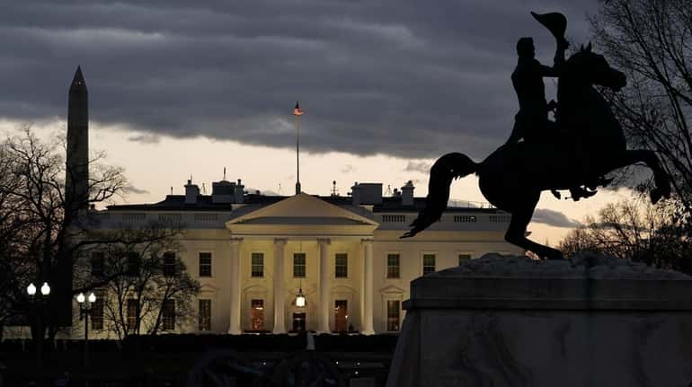 The White House sits across from Lafayette Square at dusk...