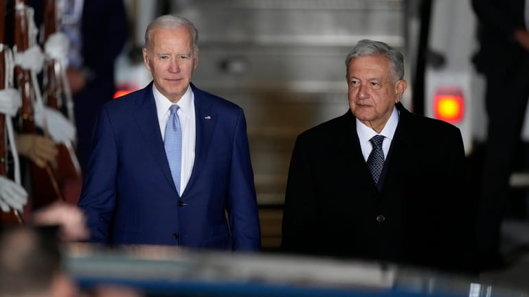 U.S. President Joe Biden walks with Mexican President Andres Manuel...