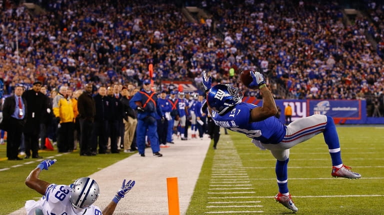 Odell Beckham #13 makes a one-handed catch in the second...
