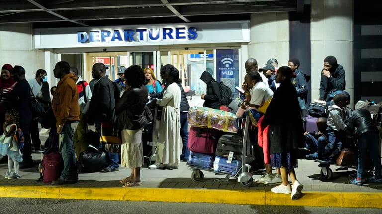 FILE- Zimbabwean evacuees from Sudan arrive at the Robert Mugabe...