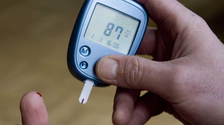 A diabetic tests his blood sugar level on Jan. 3,...