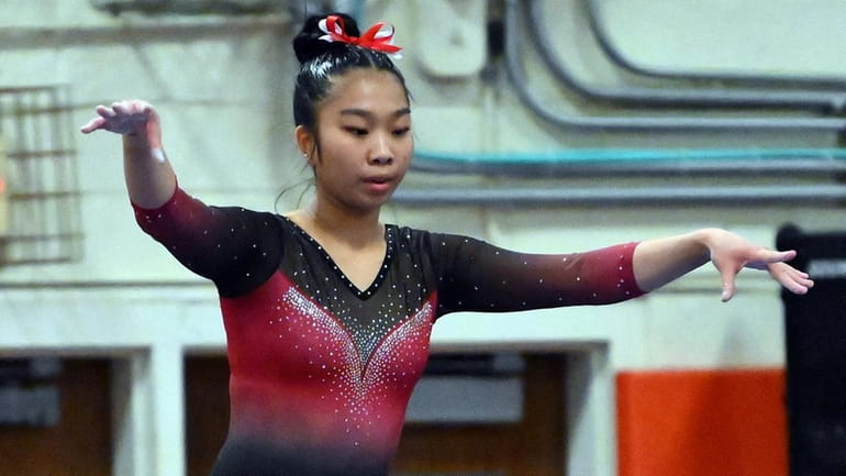 Leah Chin of Syosset, performs on the balance beam during...