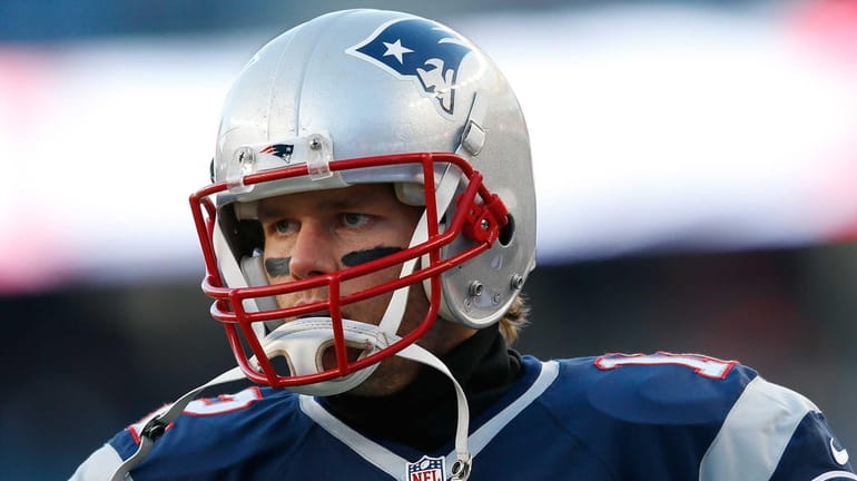 Tom Brady #12 of the New England Patriots warms up...