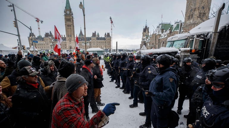 Police move in to clear protesters from downtown Ottawa near...