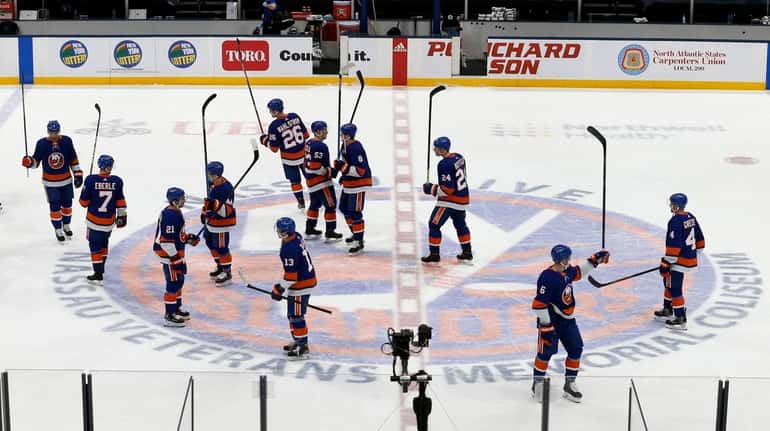 The Islanders celebrate after defeating the Rangers and clinching a...