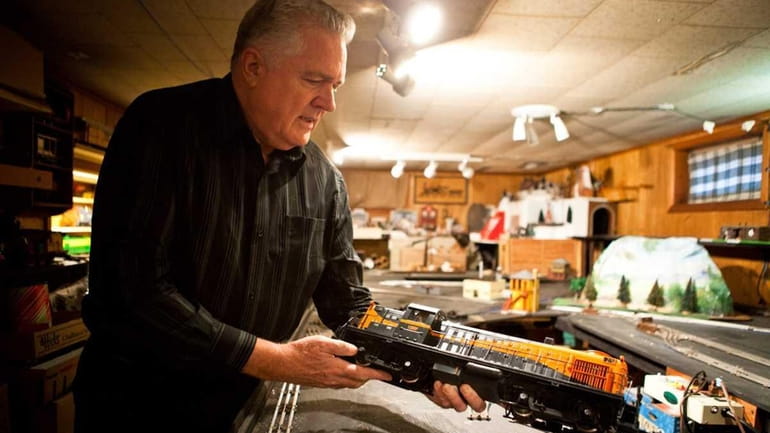 Dave Morrison handles some of his miniature trains in the...
