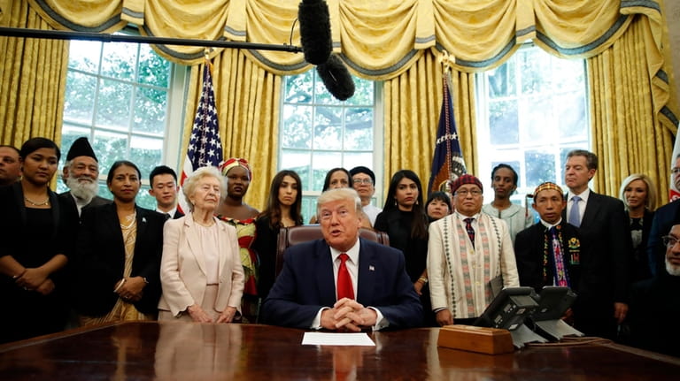President Donald Trump speaks as he meets with survivors of...