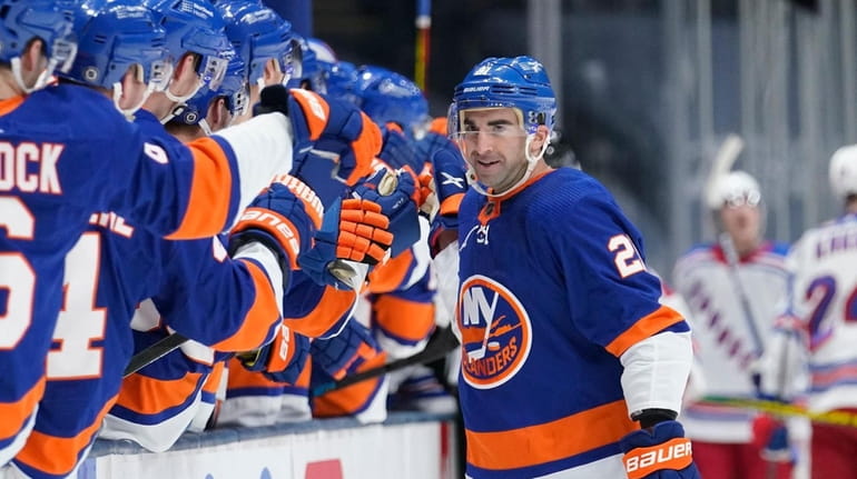 The Islanders' Kyle Palmieri (21) celebrates with teammates after scoring...