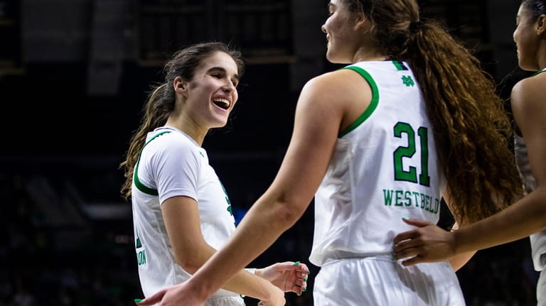 Notre Dame's Sonia Citron, left, celebrates with Maddy Westbeld (21)...