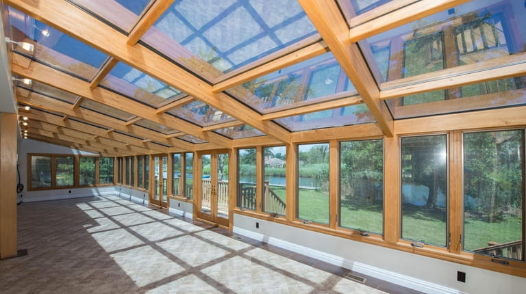 The glass solarium with has radiant heat and water views.