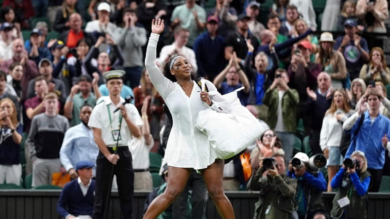 Serena Williams of the US waves as she leaves the...
