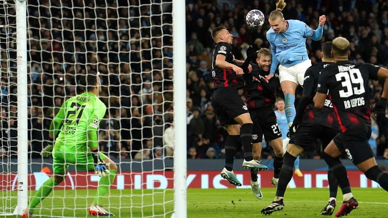 Manchester City's Erling Haaland heads the ball which led to...