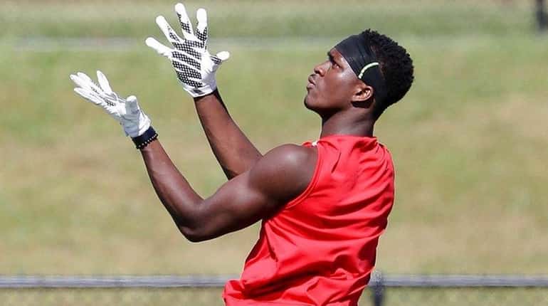Long Island's Jelani Greene (Newfield) catches a pass during Empire...