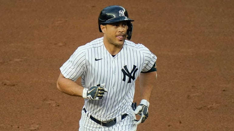 Yankees' Giancarlo Stanton runs the bases after hitting a two-run...