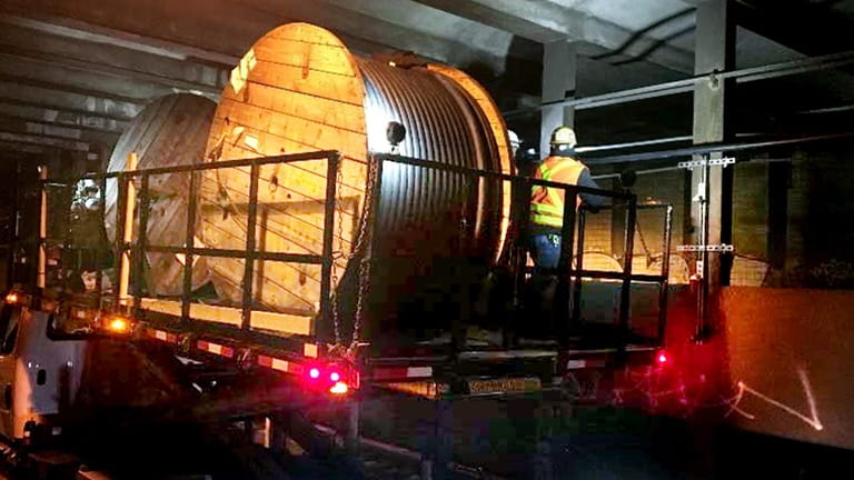 Crews install radio cable inside the LIRR's Atlantic Avenue tunnel...