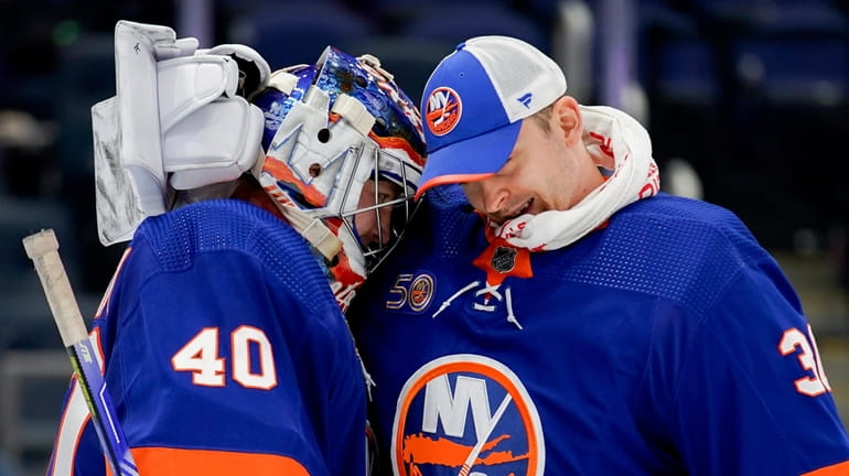 Islanders goaltenders Semyon Varlamov, left, and Ilya Sorokin hug following...