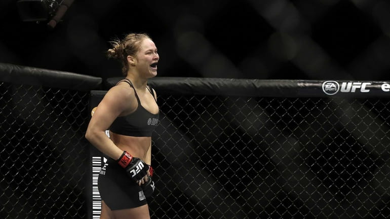 Ronda Rousey reacts after defeating Sara McMann following a UFC...