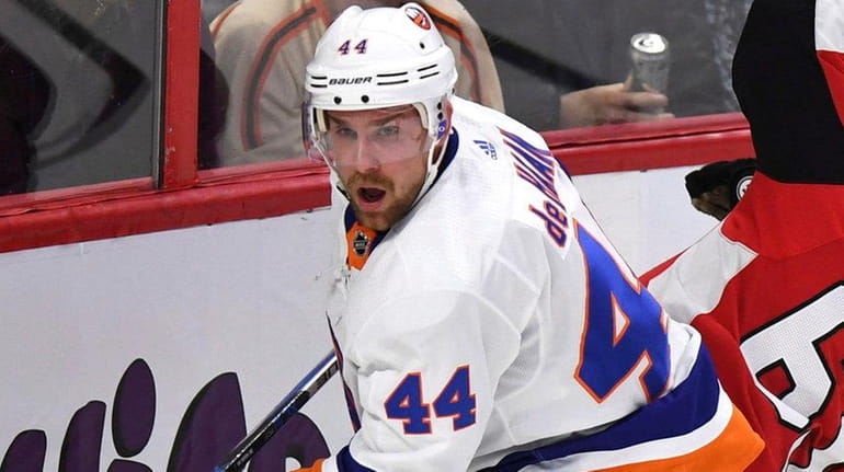 Islanders' Calvin de Haan checks Ottawa Senators' Erik Karlsson into...