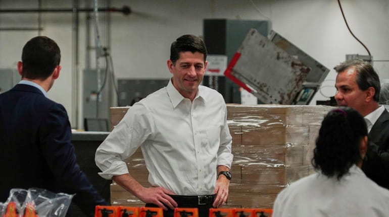 House Speaker Paul Ryan, center, tours a packaging facility in...