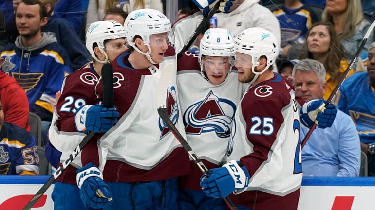 Colorado Avalanche's Logan O'Connor (25) is congratulated by teammates after...