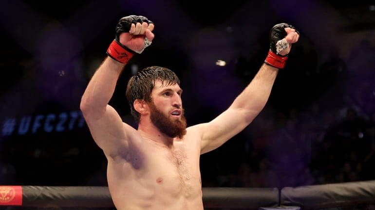 Magomed Ankalaev celebrates after defeating Anthony Smith in their light...