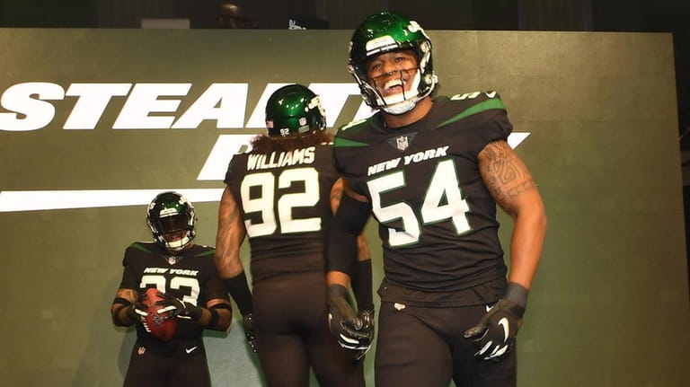 Jets players show off the "Stealth Black" uniforms at the...
