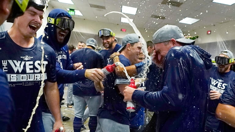 Los Angeles Dodgers celebrate in the locker room after a...