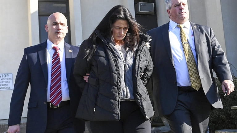 Angela Pollina is led out of Yaphank police headquarters in...