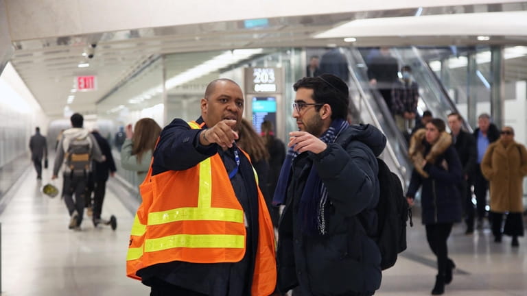A train rider asks for directions after arriving at the...
