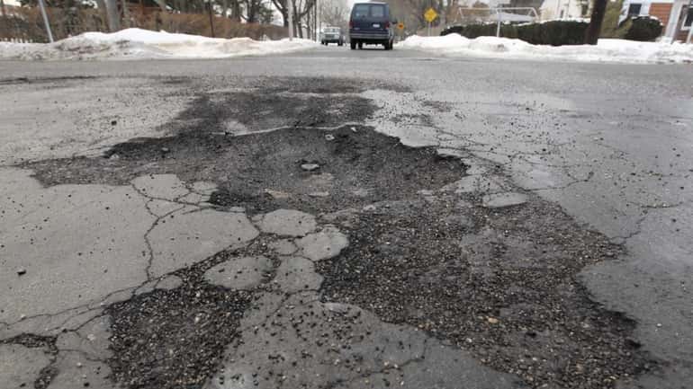 A damaged road at the intersection of Smithtown Ave. and...