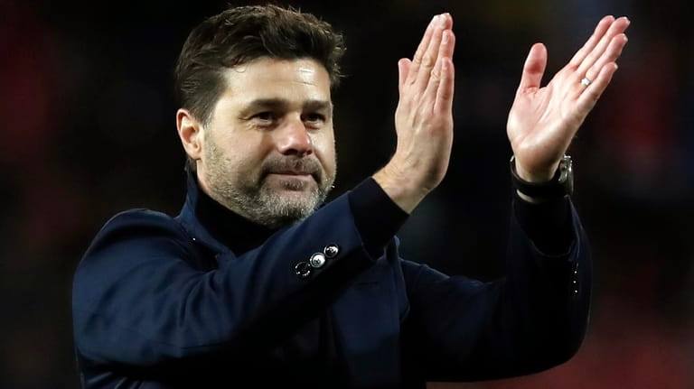 Mauricio Pochettino applauds fans after the Champions League group B...