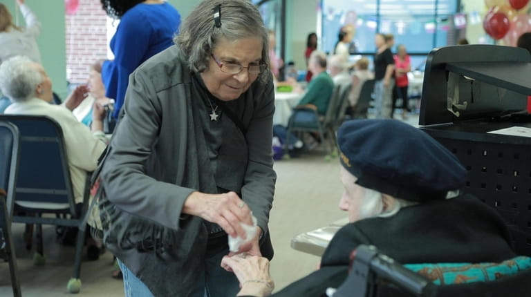 Mary Ann Romano, 77, talks to Rosalia Zona, 107, at...