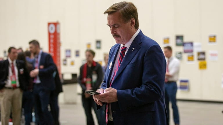 Mike Lindell, CEO of My Pillow, looks down at his...