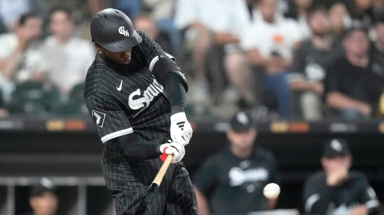 Chicago White Sox's Luis Robert Jr. hits a single off...