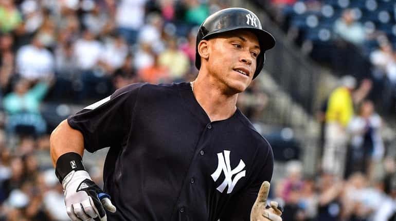 Aaron Judge #99 of the New York Yankees runs the...